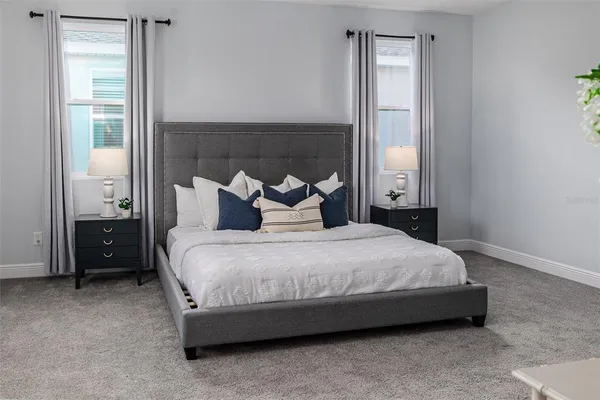 a front view of a house with a yard and trees