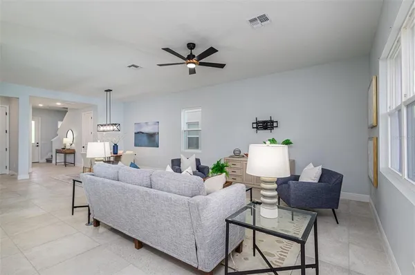 a living room with furniture and a potted plant
