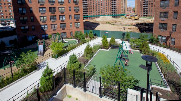 97-11 Horace Harding Expressway, Unit 18F Queens, NY 11368 - Photo 5 of 13 a view of a swimming pool with outdoor seating and plants