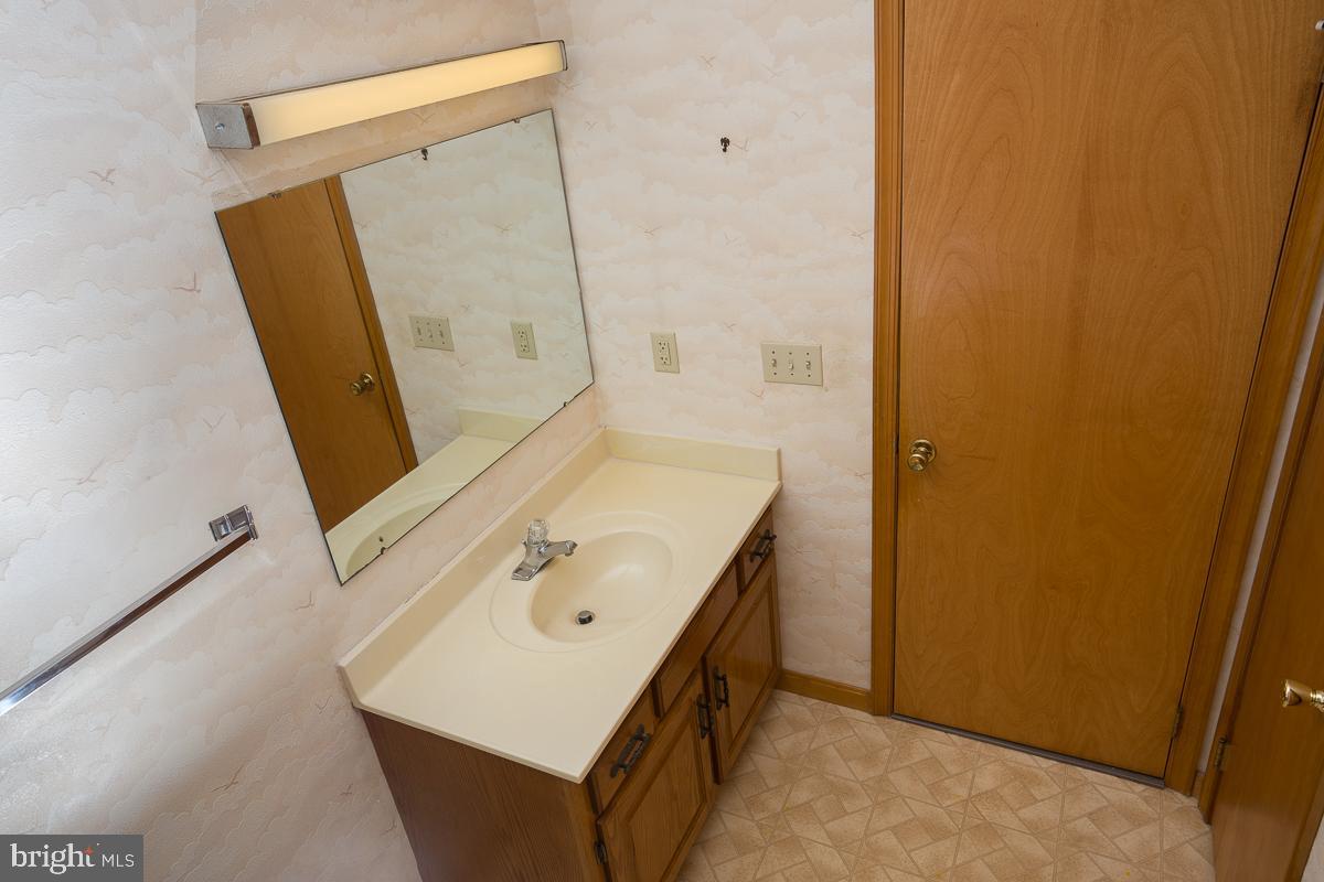 13148 Fleetwood Pond Road Seaford, DE 19973 - Photo 12 of 25 a bathroom with a sink a mirror and shower