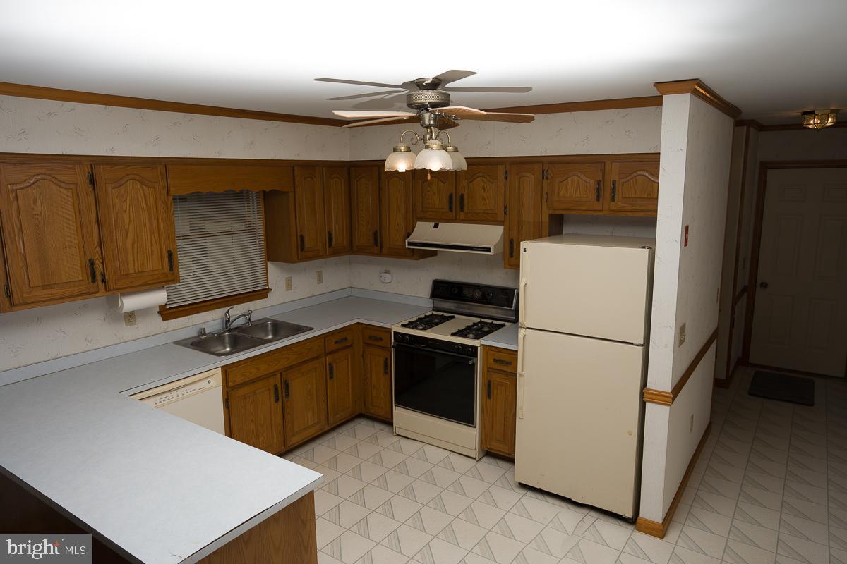 13148 Fleetwood Pond Road Seaford, DE 19973 - Photo 2 of 25 a kitchen with sink cabinets and stainless steel appliances