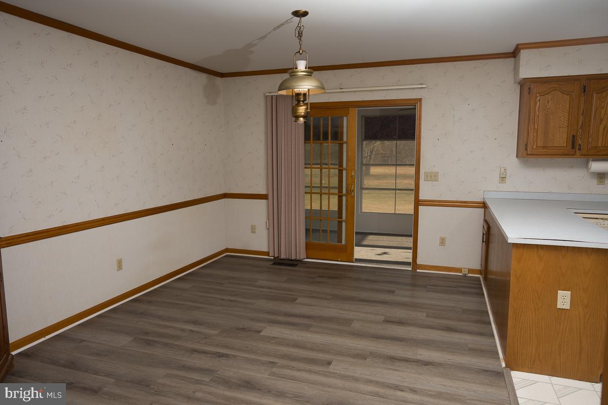 13148 Fleetwood Pond Road Seaford, DE 19973 - Photo 3 of 25 a view of an empty room with wooden floor and a window