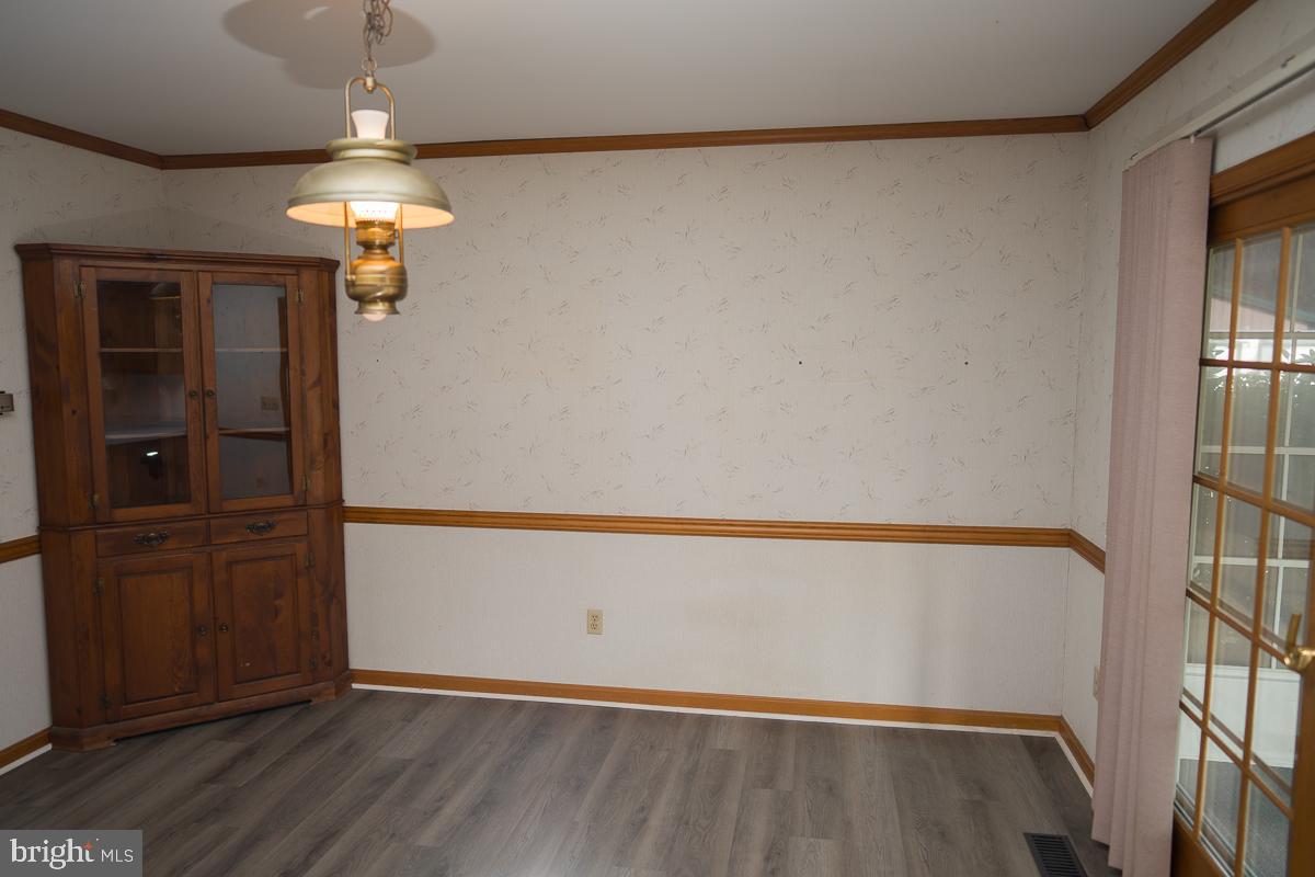 13148 Fleetwood Pond Road Seaford, DE 19973 - Photo 4 of 25 wooden floor in an empty room with a window