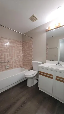 a bathroom with a sink a toilet and a bathtub