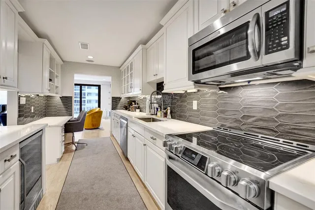 a kitchen with a stove a sink and a microwave