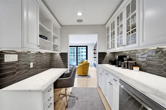 a kitchen with a sink a stove and cabinets