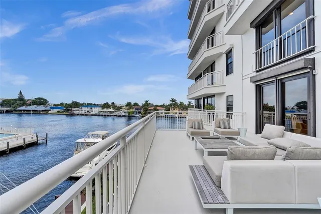 a view of balcony with outdoor seating and lake