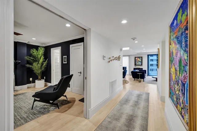 a living room with furniture and floor to ceiling window