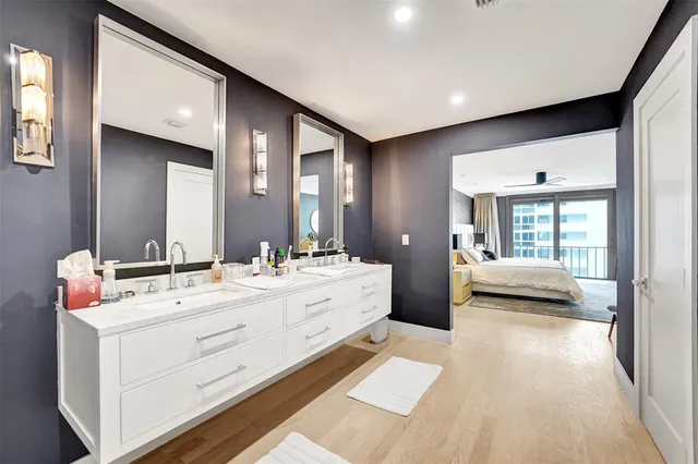 a spacious bathroom with a double vanity sink and mirror