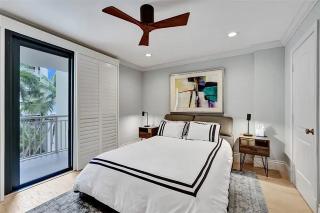 a bed room with a bed and a painting on the wall