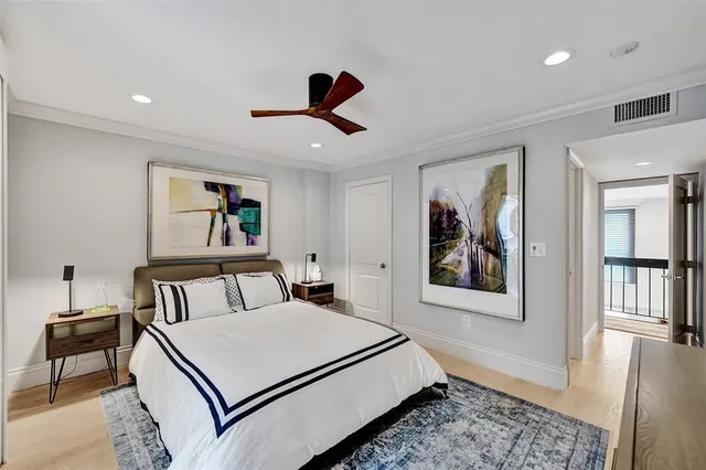 a bedroom with a bed and a painting on the wall