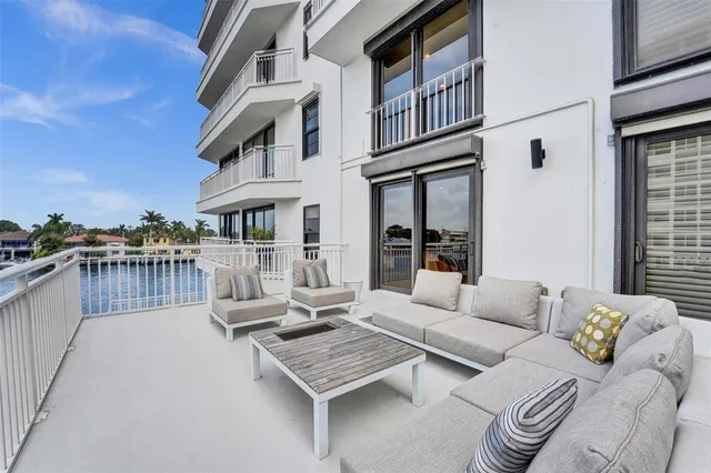 a view of a patio with couches and a table and chairs