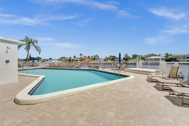 a view of a swimming pool and lounge chairs