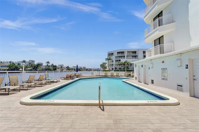 a view of a swimming pool with a lounge chair