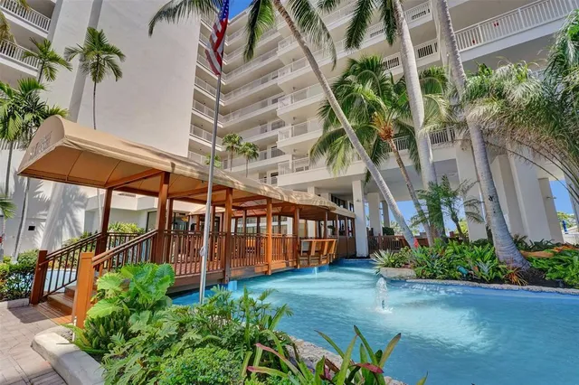 a view of a house with a yard and potted plants
