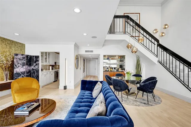 a living room with furniture and a chandelier