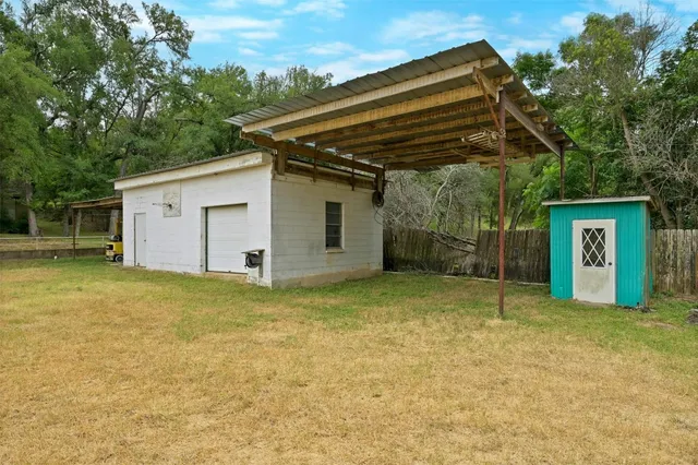 a backyard of a house with table and chairs