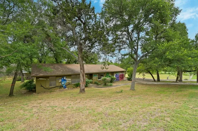 a view of a house with a yard and sitting area