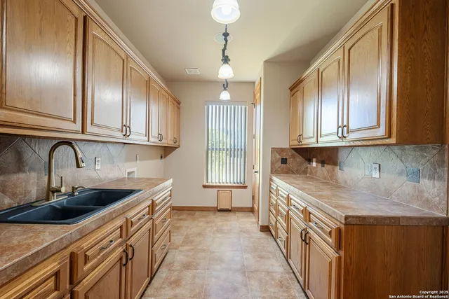a kitchen with stainless steel appliances granite countertop a sink and a stove