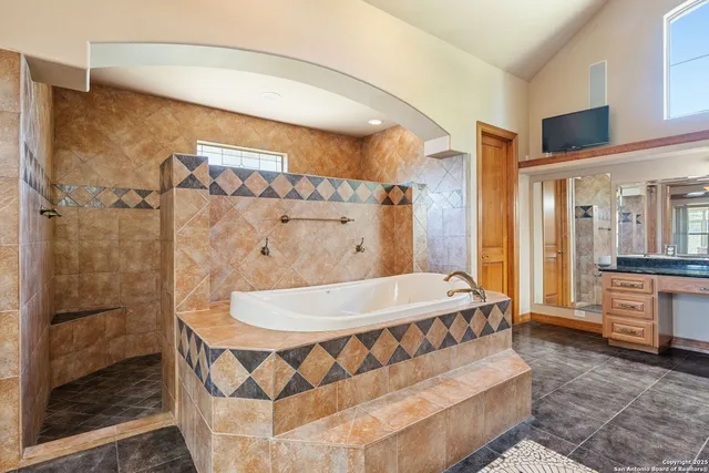 a bathroom with a bathtub and a shower