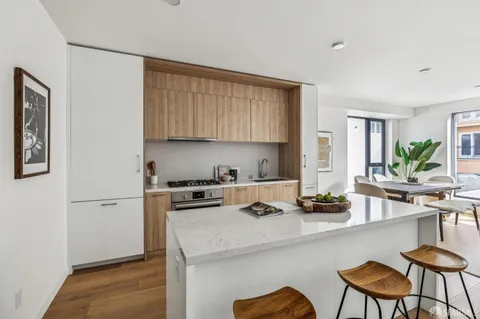 a kitchen with a sink cabinets and window