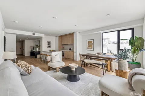 a kitchen with a table chairs stove and cabinets
