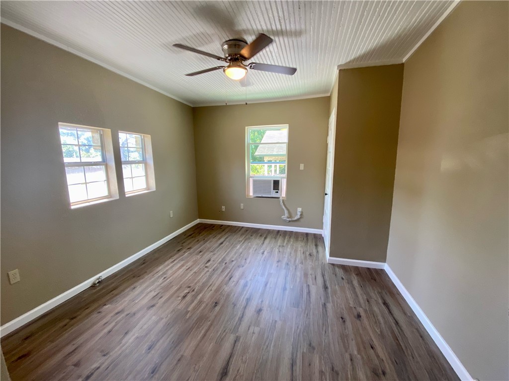 1306 Perez Street Austin, TX 78721 - Photo 8 of 17 a view of empty room with wooden floor and fan
