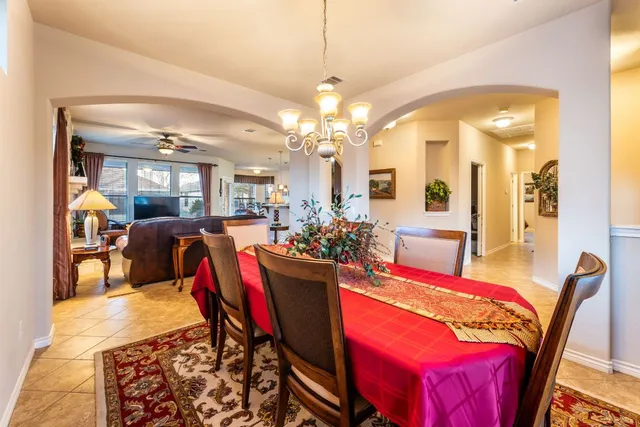 a view of a dining room with furniture and chandelier