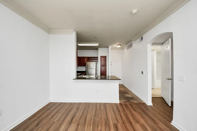 a view of a kitchen with wooden floor and a sink