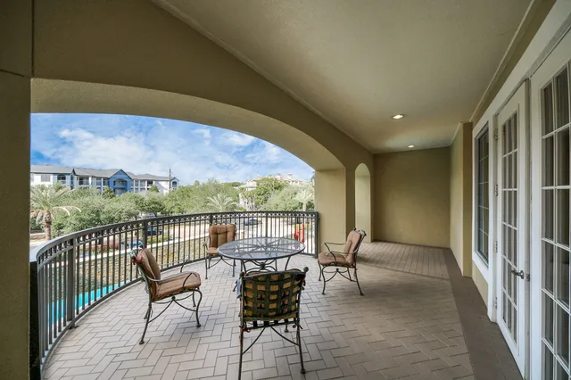 a view of a chairs and table in the balcony