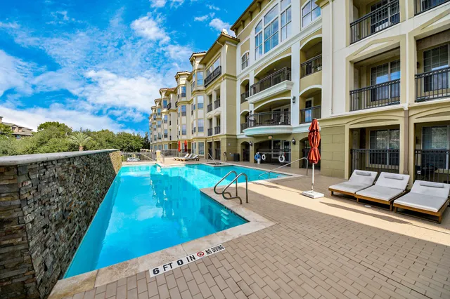 a view of an swimming pool with a lounge chairs