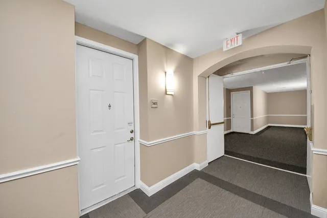 a view of a hallway with entryway and window