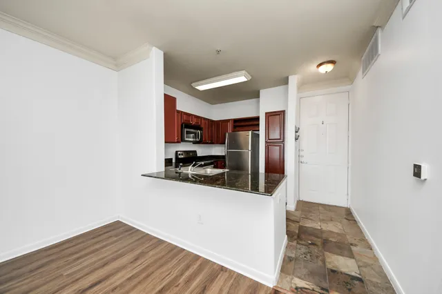 a kitchen with stainless steel appliances a refrigerator and a stove top oven