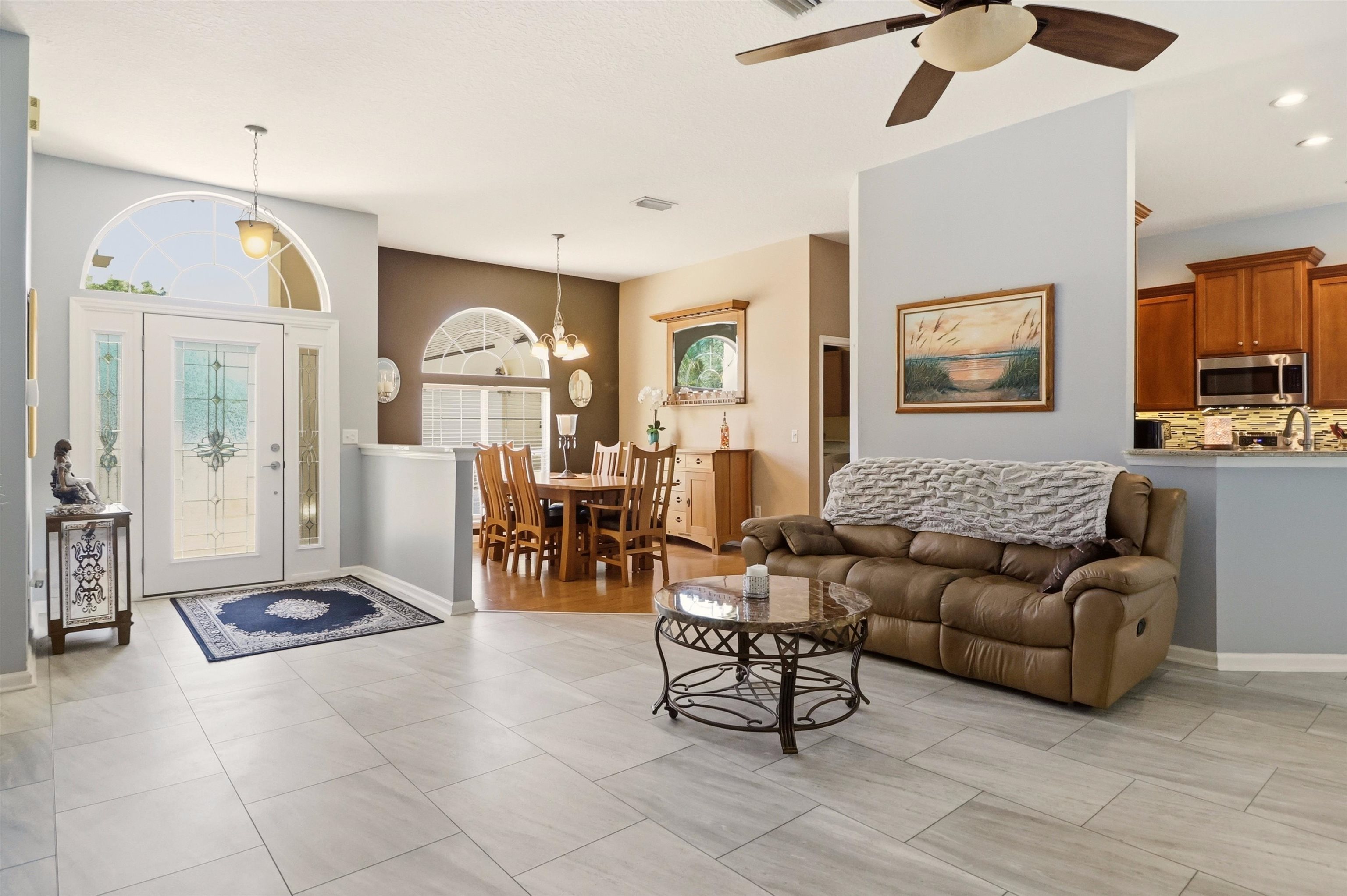 273 Whisper Ridge Drive St. Augustine, FL 32092 - Photo 14 of 44 Living area featuring ceiling fan and suspended lighting