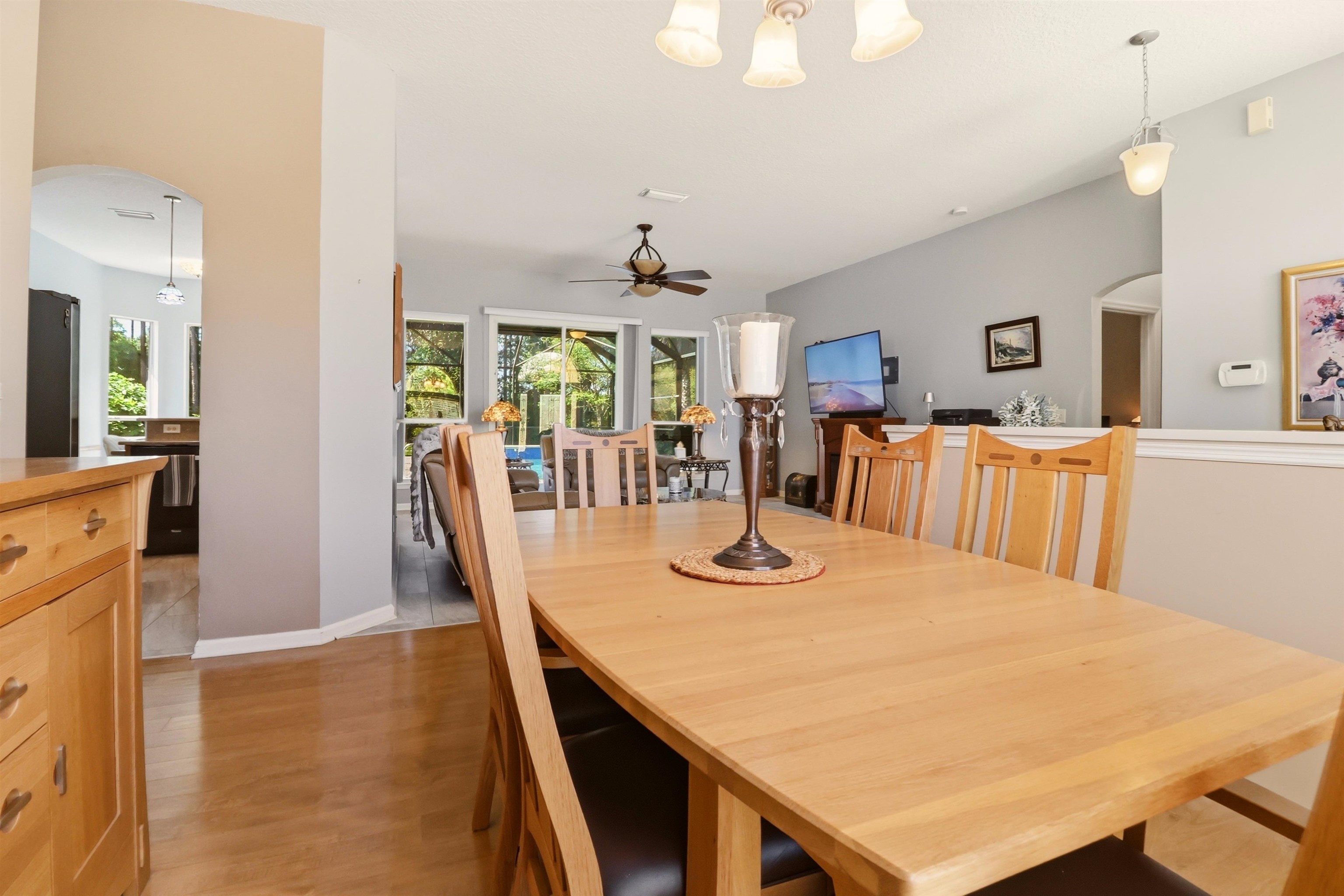 273 Whisper Ridge Drive St. Augustine, FL 32092 - Photo 17 of 44 Dining room featuring arched walkways, light wood finished floors, and ceiling fan