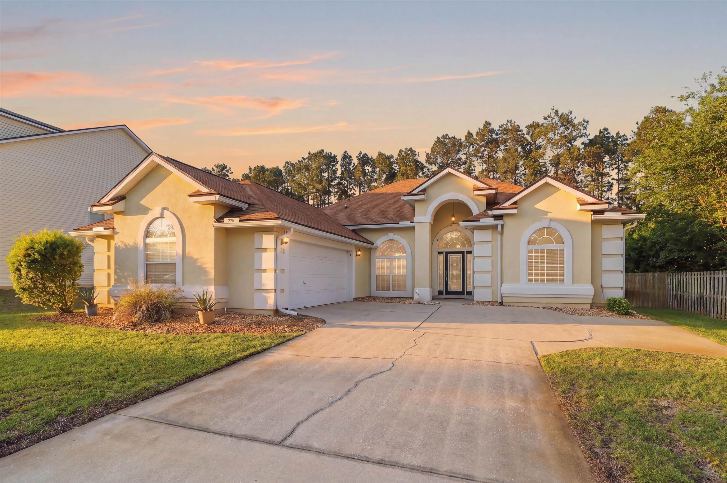 273 Whisper Ridge Drive St. Augustine, FL 32092 - Photo 2 of 44 Mediterranean / spanish-style house featuring stucco siding, concrete driveway, and a garage