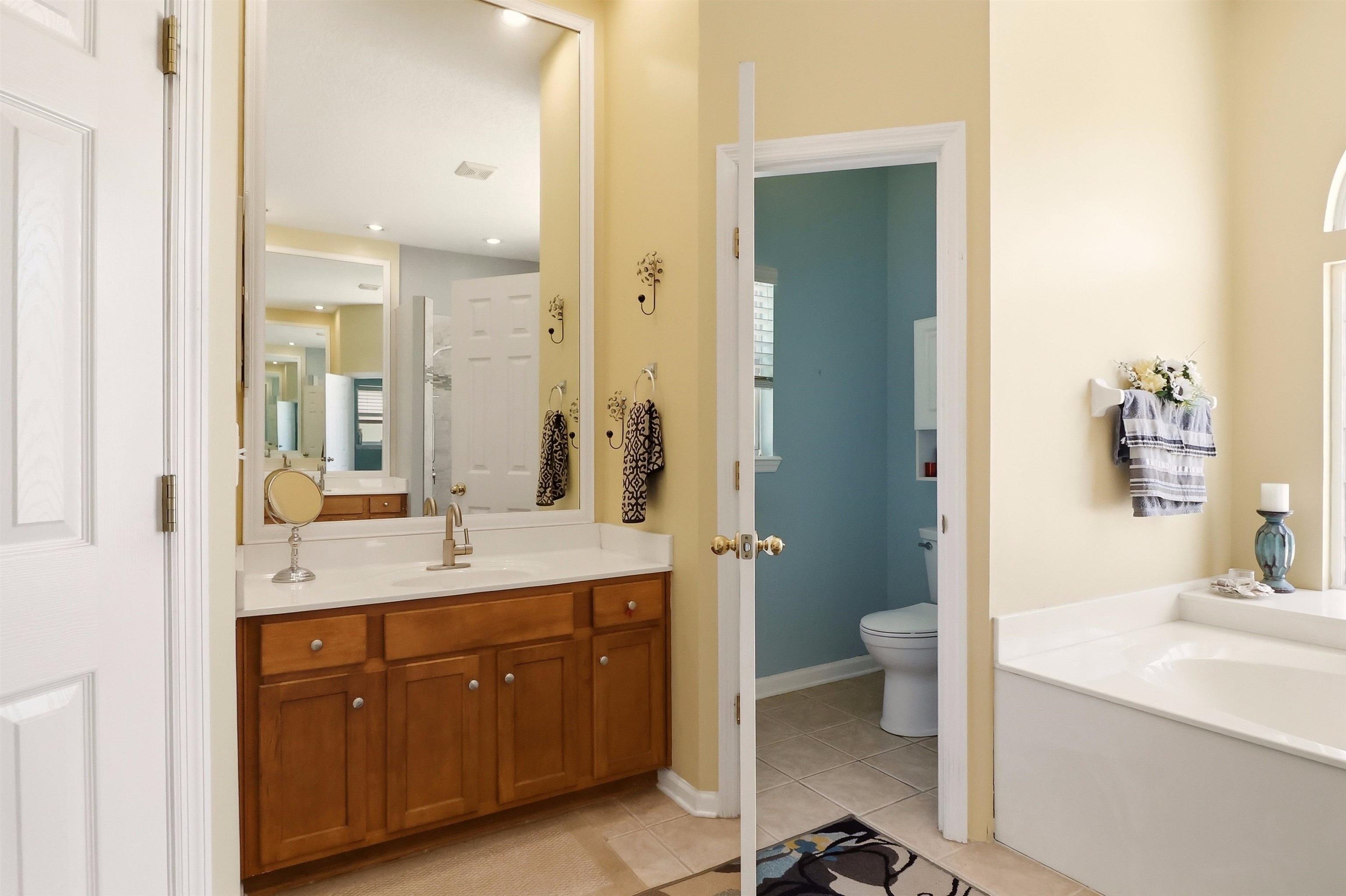 273 Whisper Ridge Drive St. Augustine, FL 32092 - Photo 28 of 44 Bathroom featuring light tile patterned flooring, vanity, and a bath