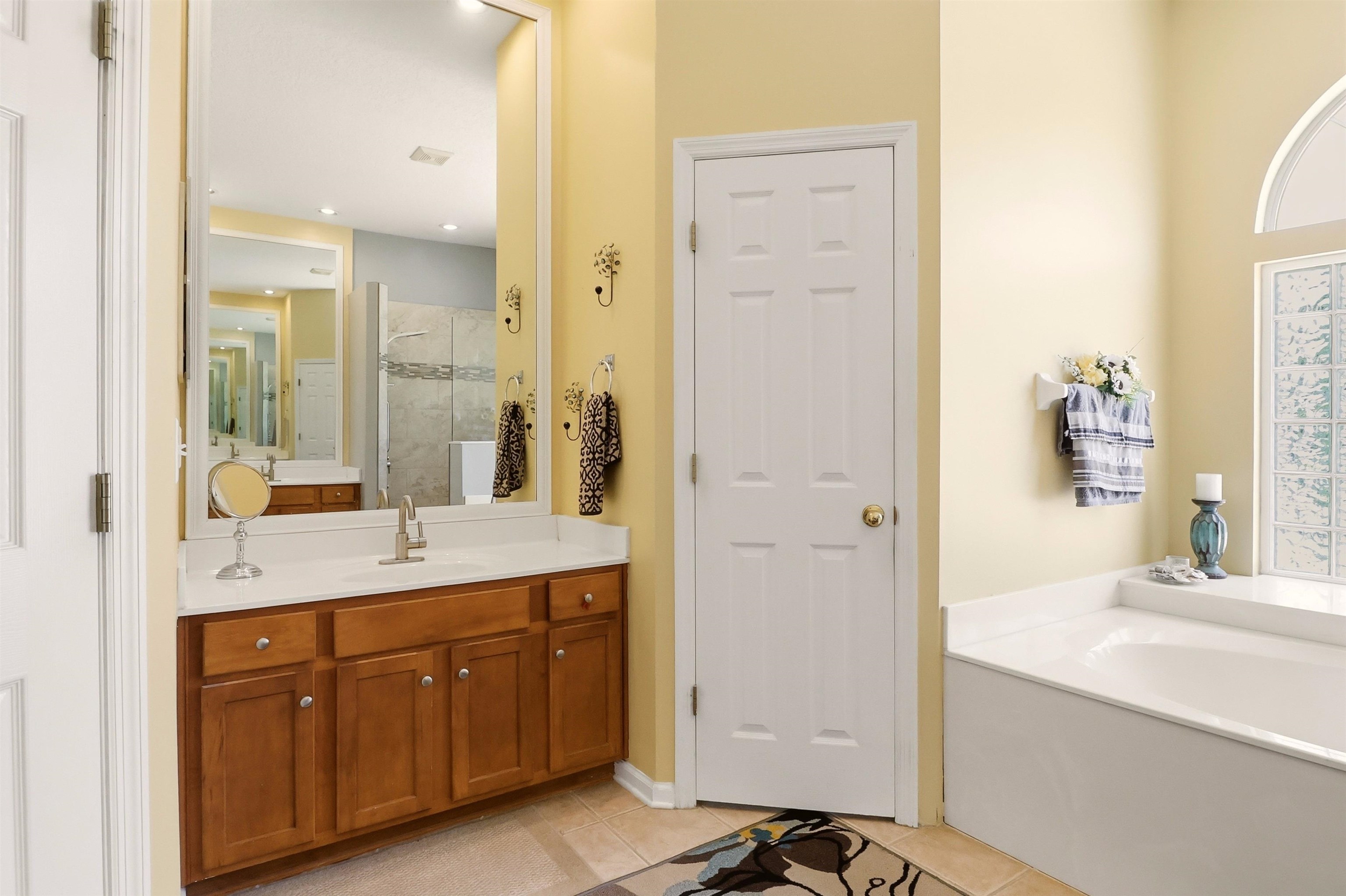 273 Whisper Ridge Drive St. Augustine, FL 32092 - Photo 29 of 44 Full bath featuring a shower stall, vanity, light tile patterned floors, and a garden tub