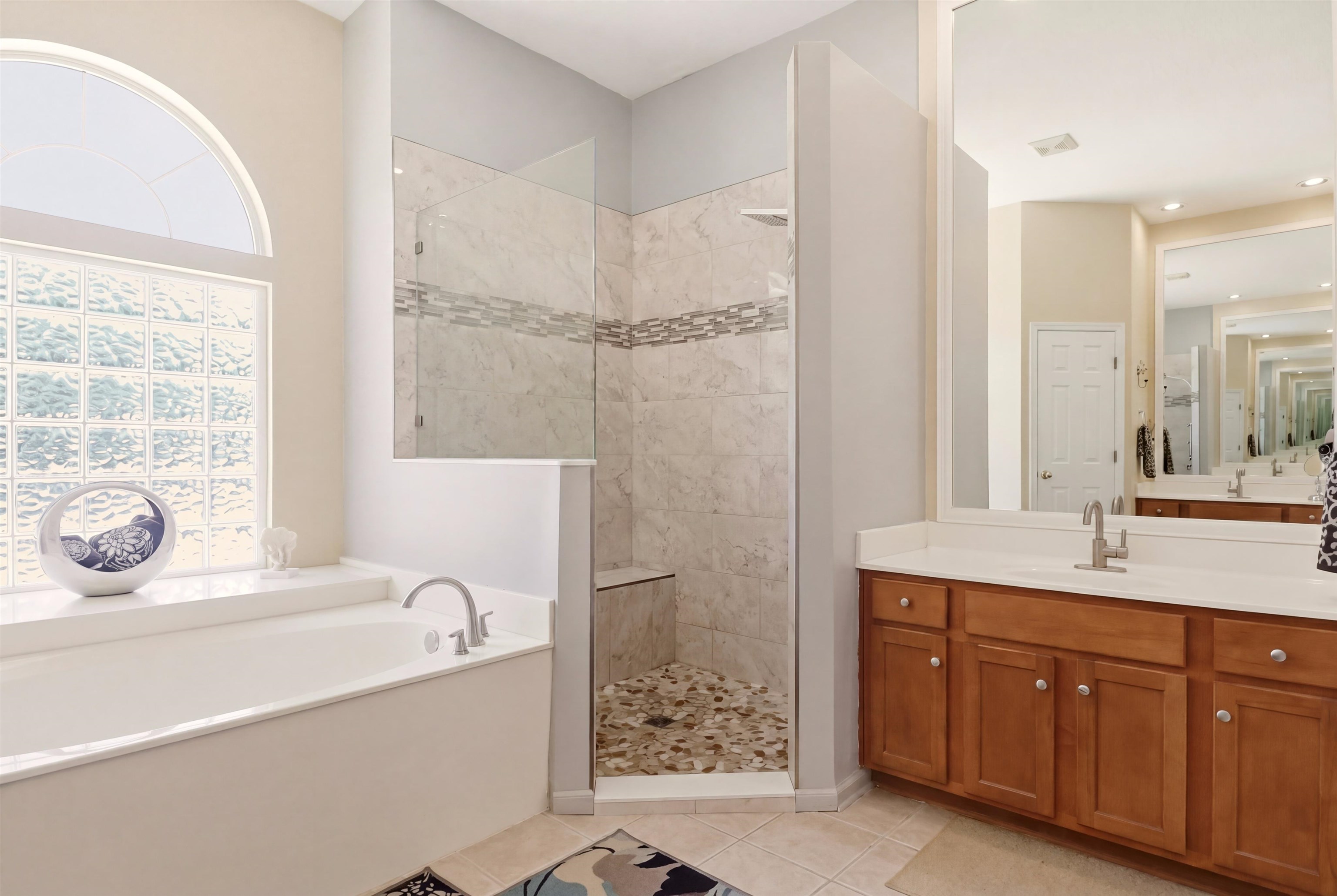 273 Whisper Ridge Drive St. Augustine, FL 32092 - Photo 30 of 44 Bathroom featuring walk in shower, a bath, vanity, and light tile patterned floors