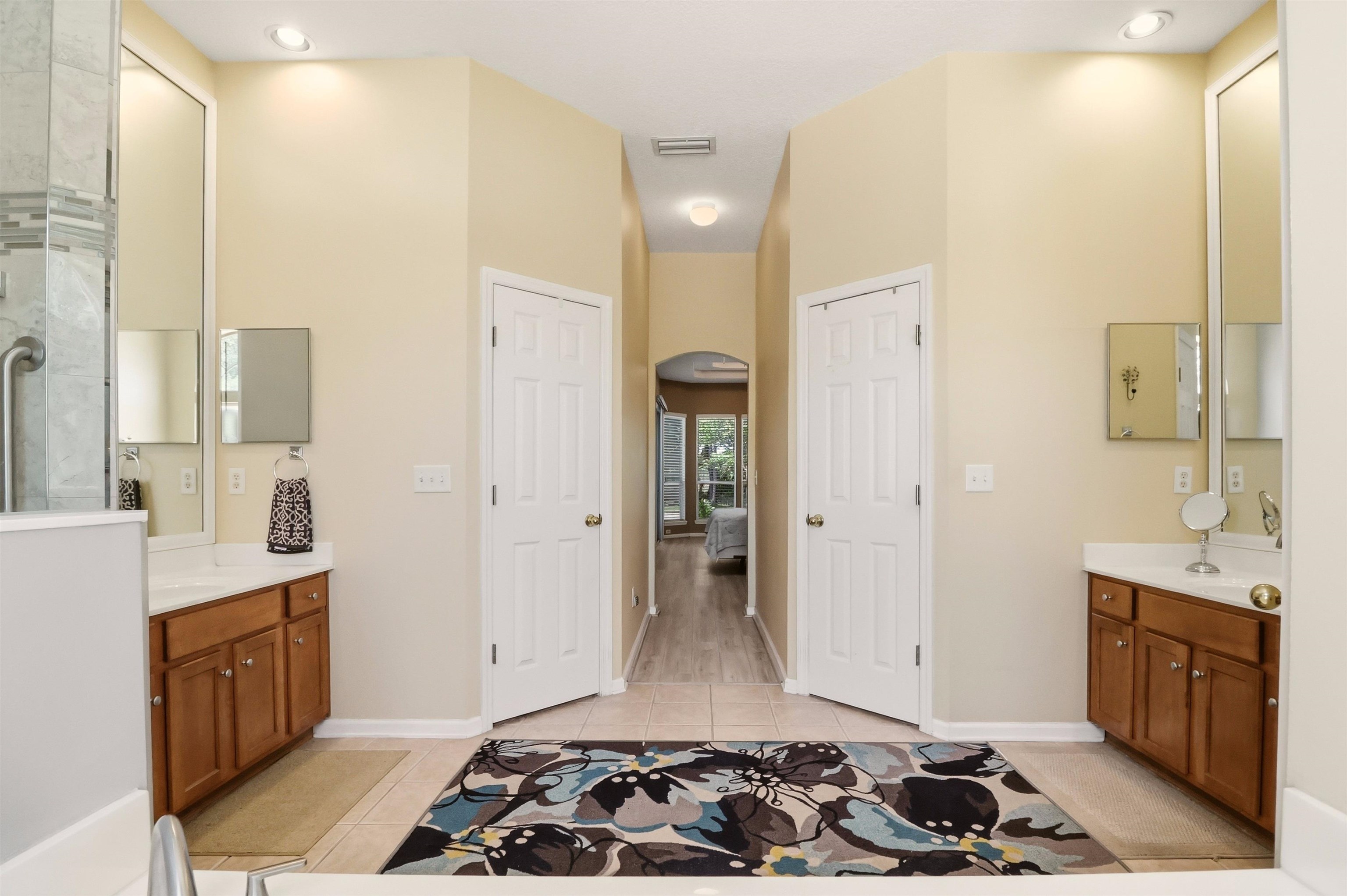 273 Whisper Ridge Drive St. Augustine, FL 32092 - Photo 31 of 44 Full bath with two vanities, light tile patterned flooring, and ensuite bath