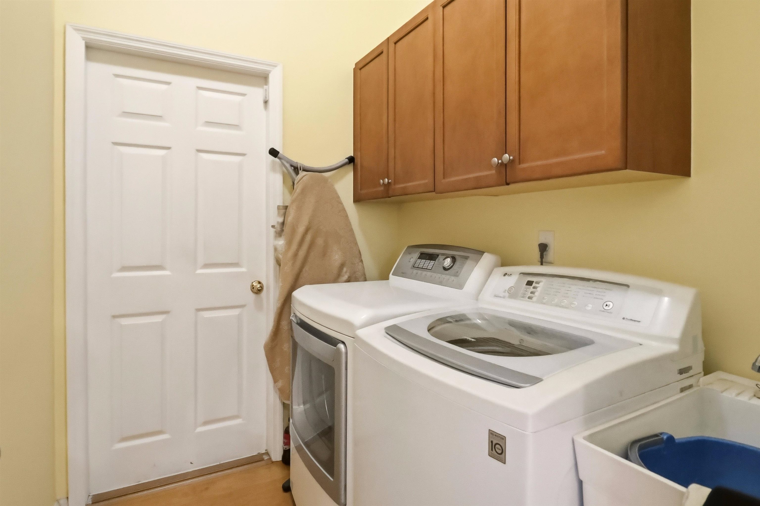 273 Whisper Ridge Drive St. Augustine, FL 32092 - Photo 32 of 44 Laundry area featuring washer and clothes dryer and cabinet space