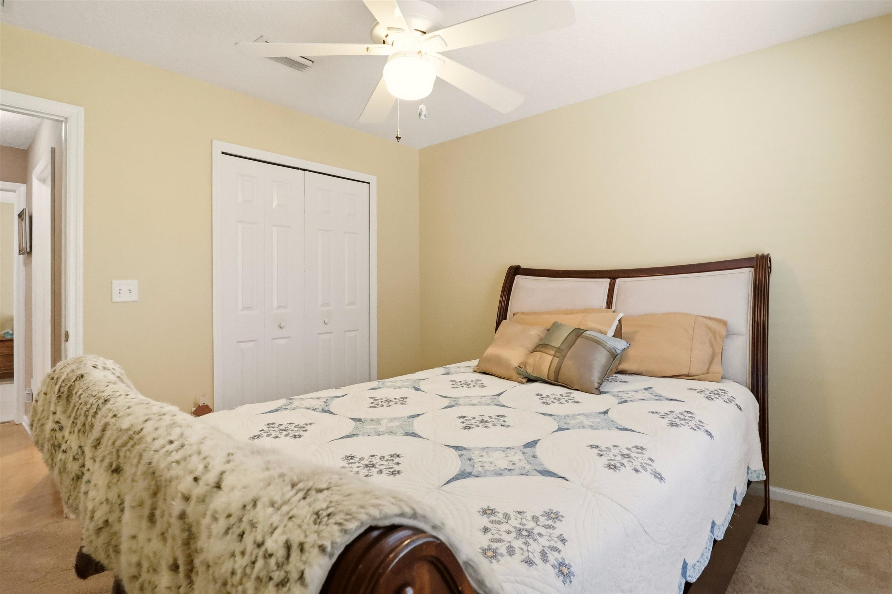 273 Whisper Ridge Drive St. Augustine, FL 32092 - Photo 38 of 44 Bedroom with light colored carpet, a closet, and a ceiling fan
