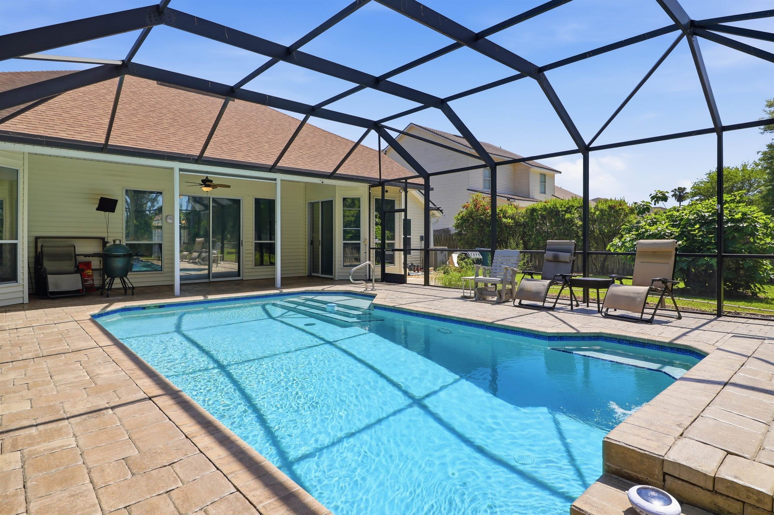 273 Whisper Ridge Drive St. Augustine, FL 32092 - Photo 43 of 44 Partially fenced in back yard featuring screened in heated pool and patio area