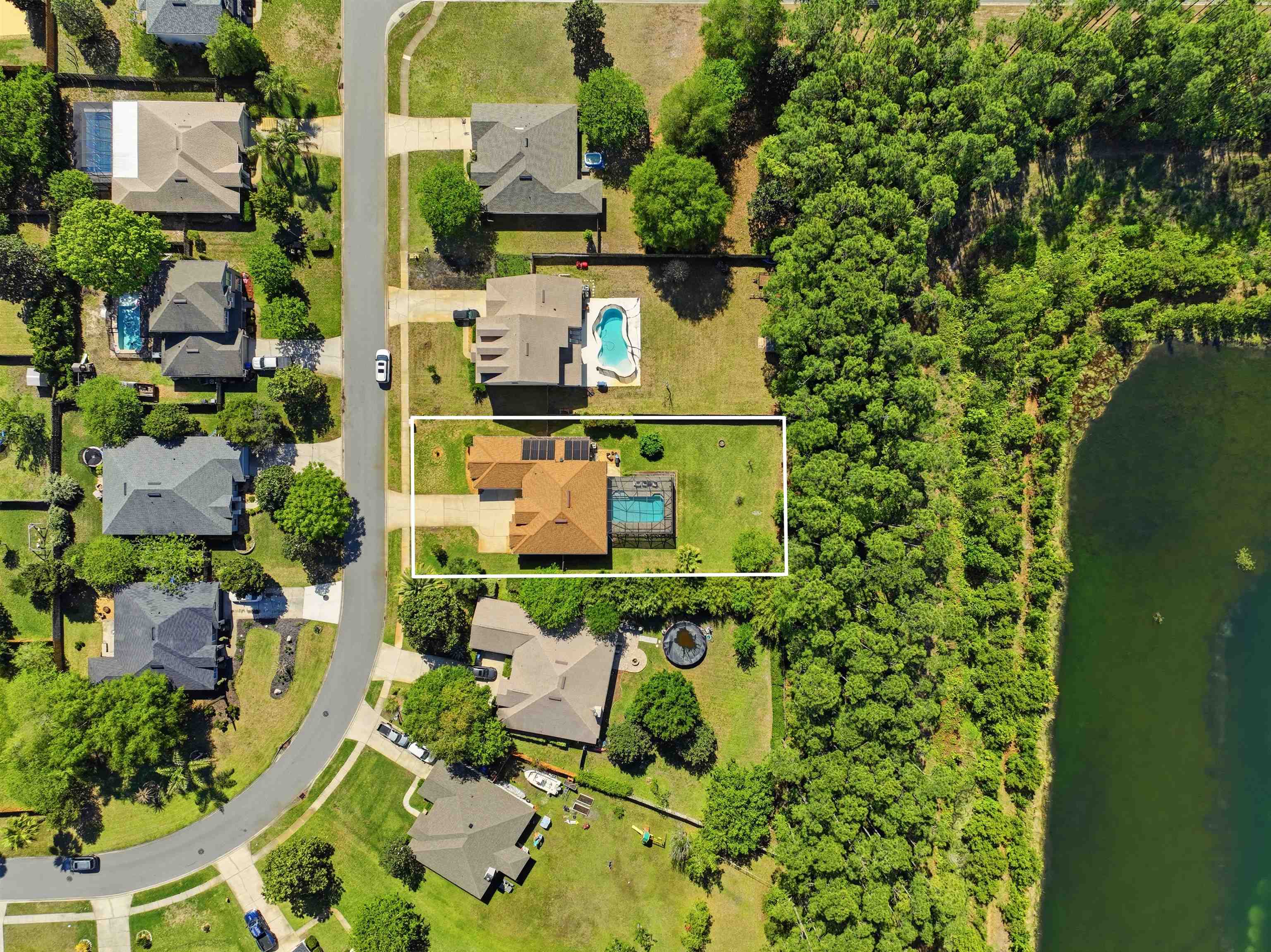 273 Whisper Ridge Drive St. Augustine, FL 32092 - Photo 6 of 44 Aerial perspective of suburban area with property parcel outlined and lake views