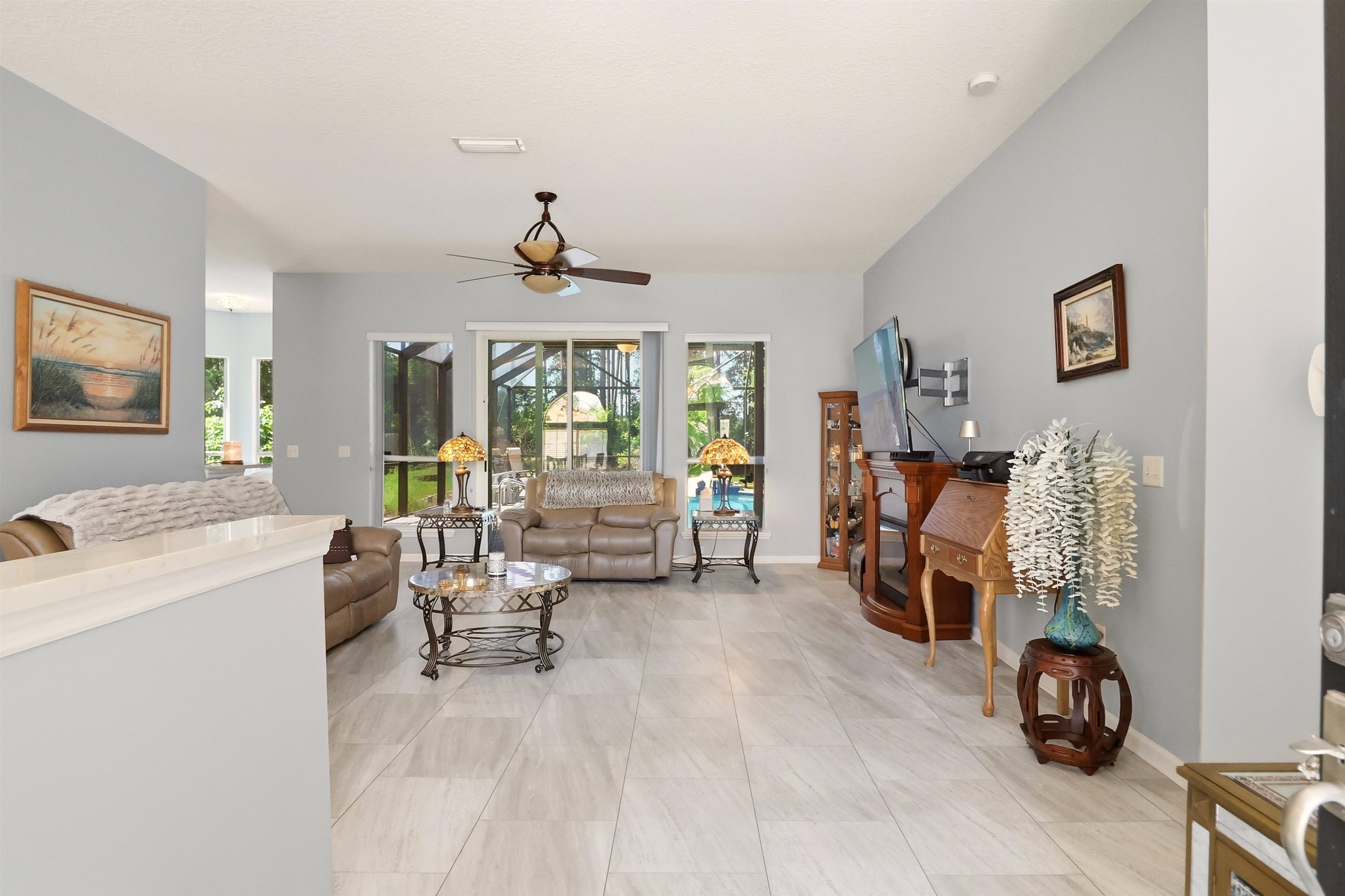 273 Whisper Ridge Drive St. Augustine, FL 32092 - Photo 10 of 44 Living room featuring ceiling fan and light tile patterned floors