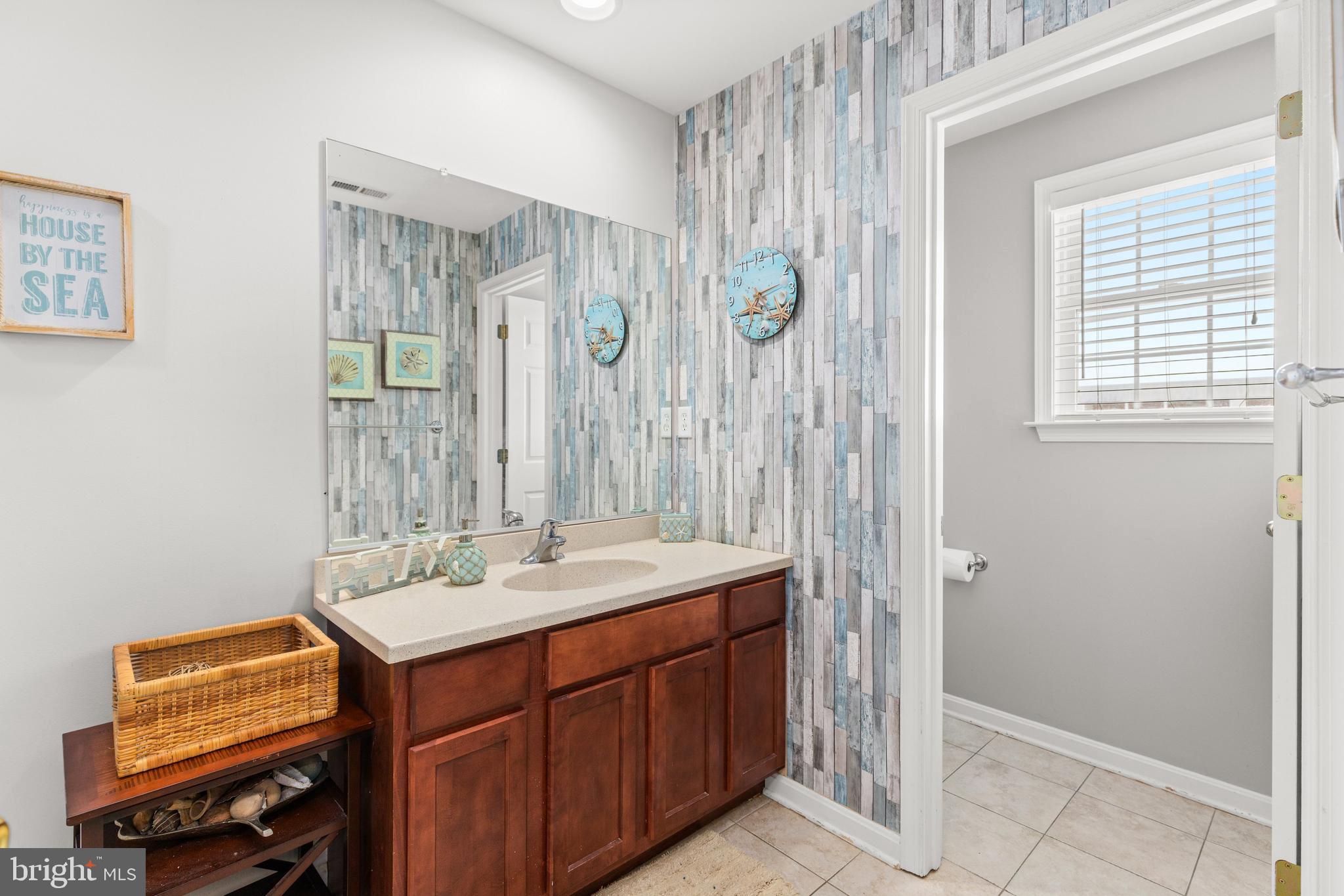 617 Salt Spray Road, Unit B Ocean City, MD 21842 - Photo 56 of 72 a bathroom with a sink and a mirror