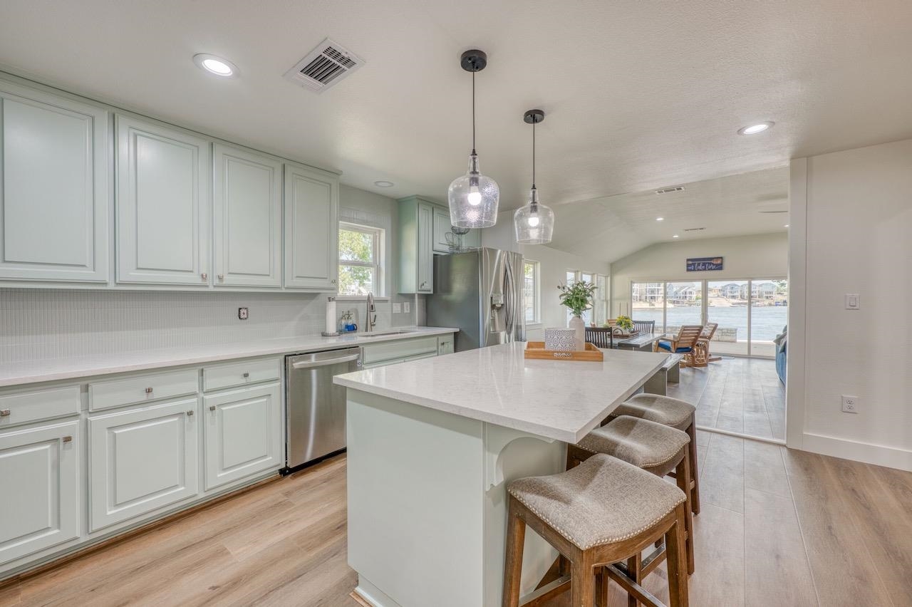 569 Ellen Williams Loop Kingsland, TX 78639 - Photo 11 of 29 a large kitchen with kitchen island a island a sink a stove and wooden floor