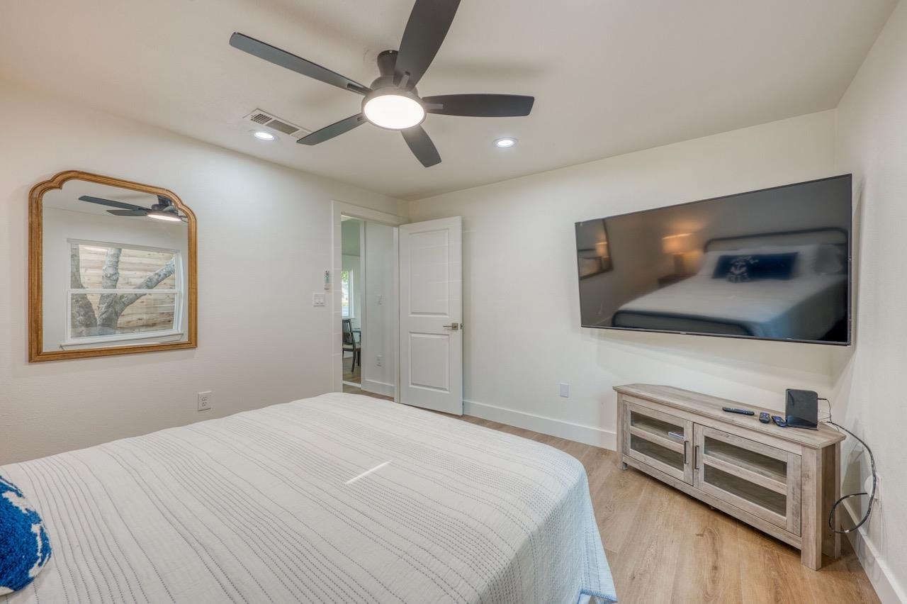 569 Ellen Williams Loop Kingsland, TX 78639 - Photo 18 of 29 a bedroom with a bed and a flat screen tv