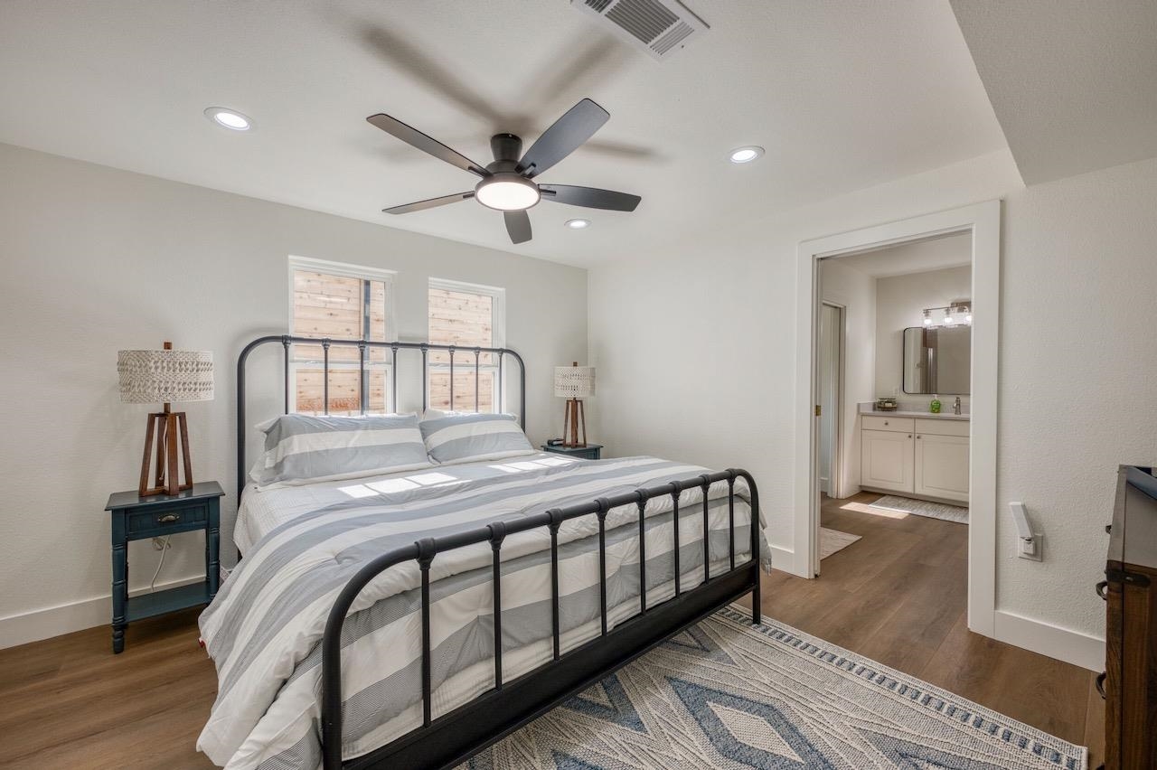 569 Ellen Williams Loop Kingsland, TX 78639 - Photo 23 of 29 a bedroom with a bed and wooden floor