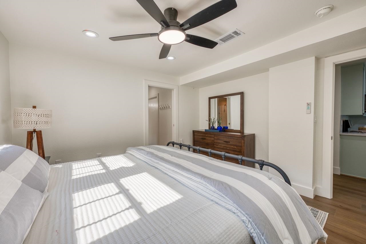 569 Ellen Williams Loop Kingsland, TX 78639 - Photo 24 of 29 a bedroom with a bed and a chandelier